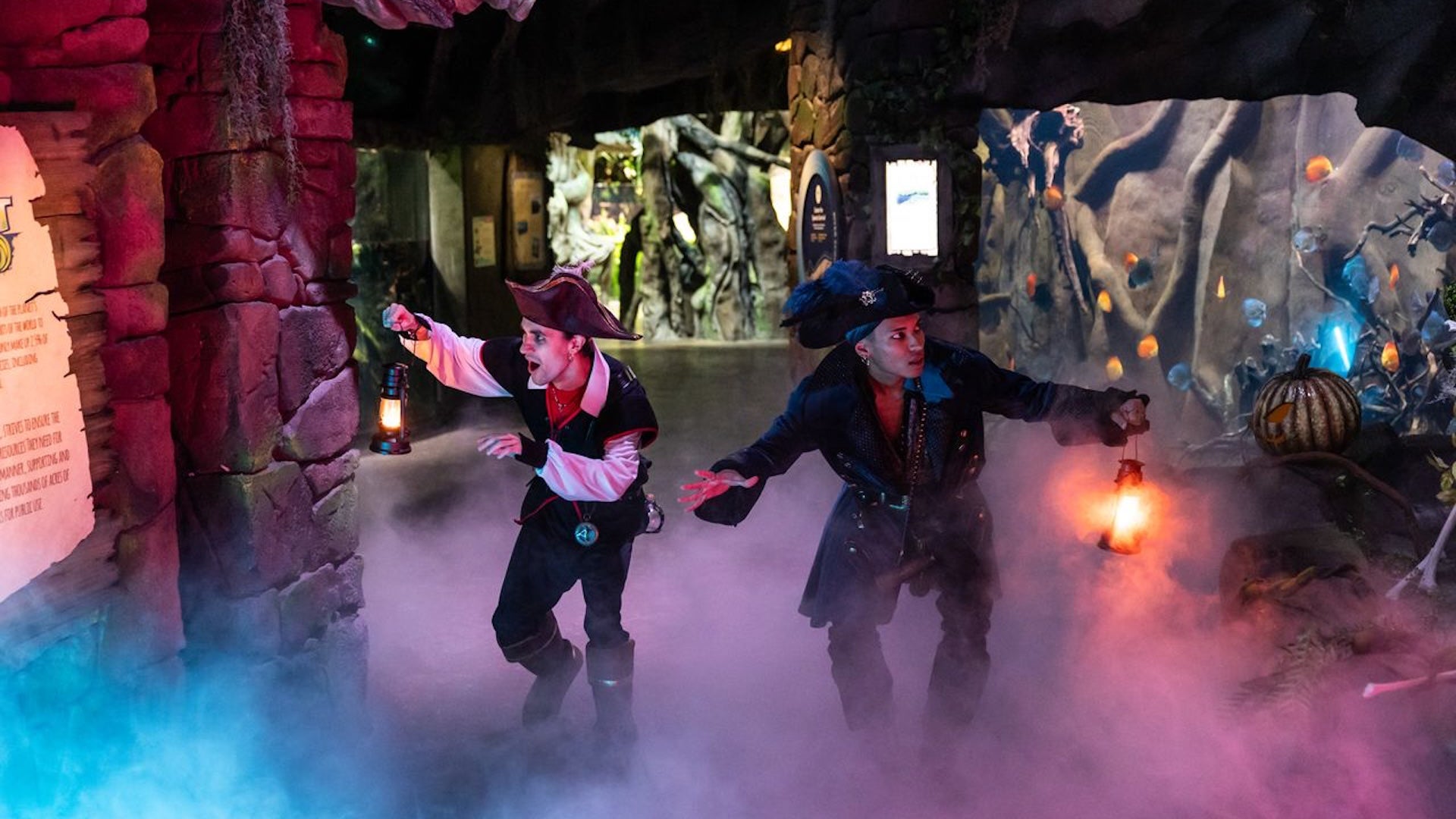 two men wearing pirate costumes and holding flame lights